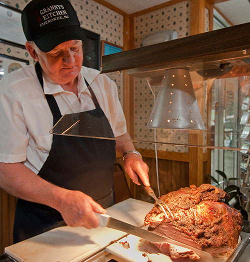 Chef carving roast beef at the buffet