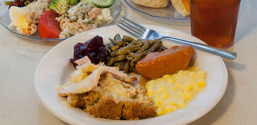 plate of turket and dressing, vegetables and salad, biscuits and tea